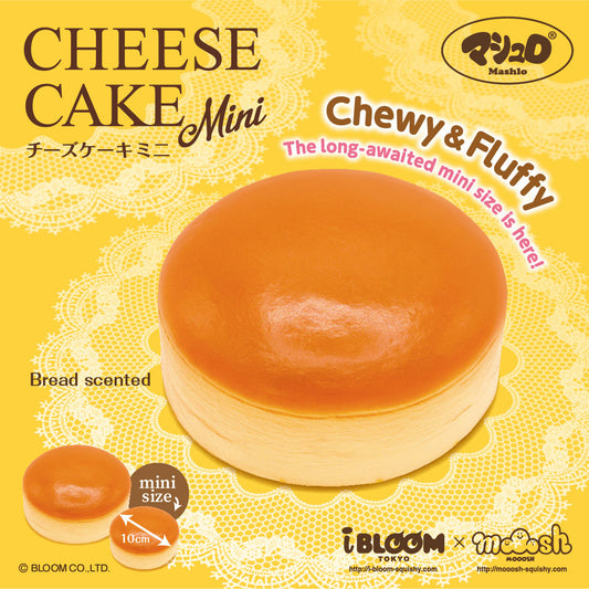 A yellow retail package graphic for a mini cheese cake squishy by the brand IBLOOM. The package shows a round, pale beige cake with a glossy amber-orange top, plus smaller inset views of the mini cake and text reading 'CHEESE CAKE Mini,' 'Chewy & Fluffy,' 'Bread scented,' and '10cm. 