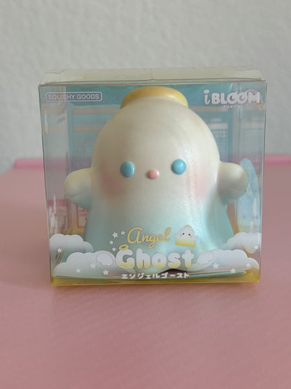 An iBLOOM Angel Ghost squishy toy in its original packaging, featuring a cute pastel-blue angel ghost with blue eyes and a yellow halo, labeled 'Angel Ghost'.